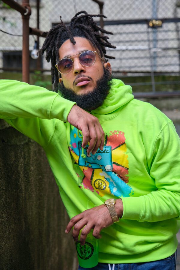 A Man in a Green Color Hoodie With a Color Print